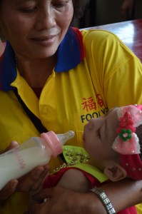 A baby taken care by a care-giver